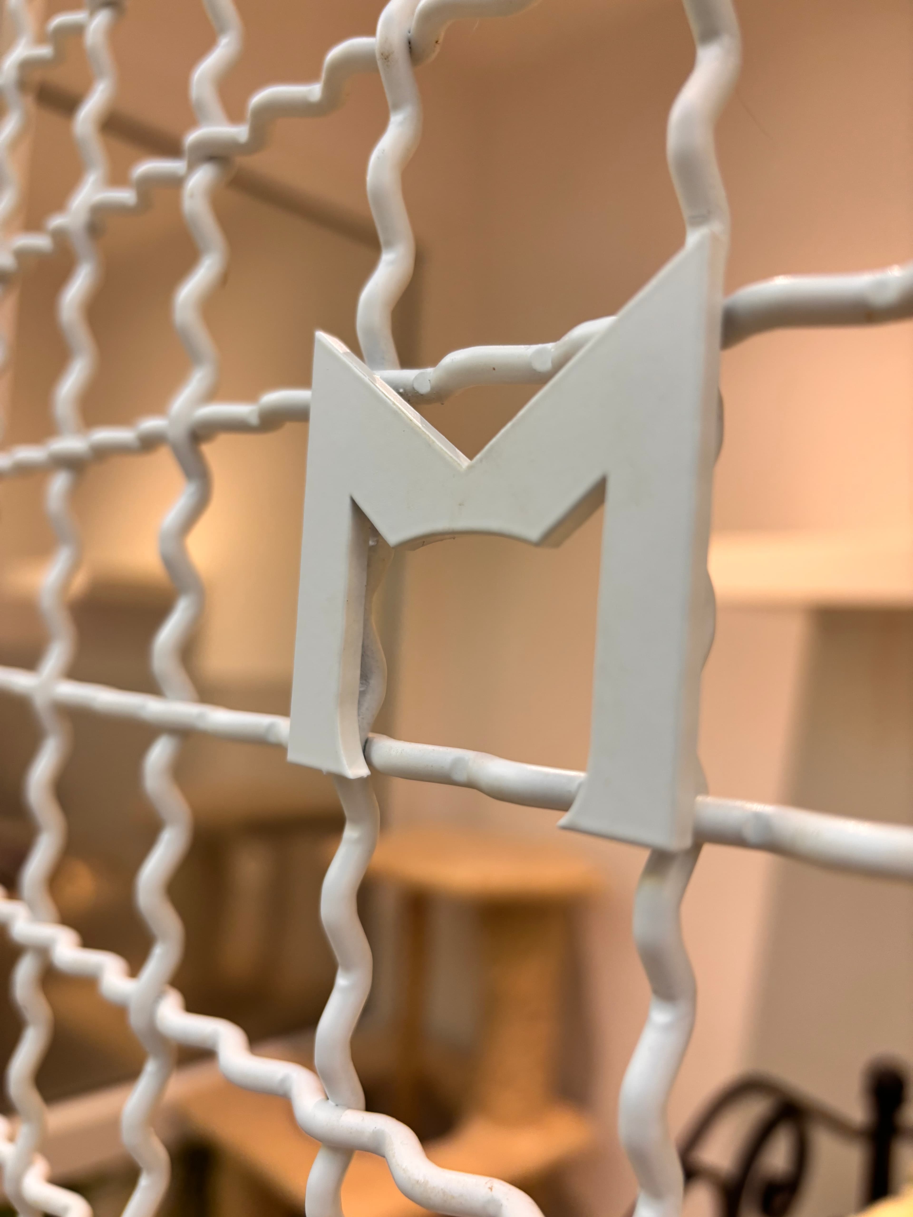 The letter M on a room door at Hotel Mascotas.